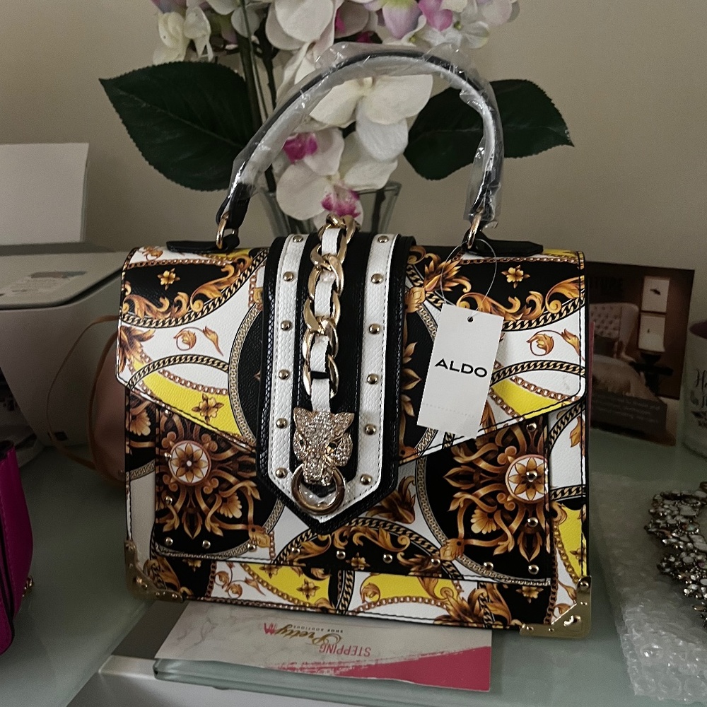 Black, yellow, white and gold aldo bag with tiger stud buckle